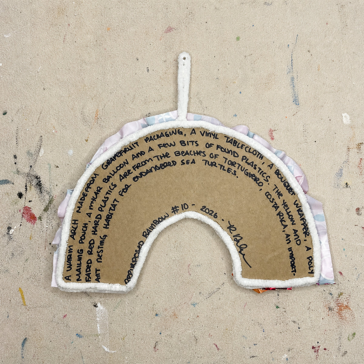 Arch-shaped object with text on a textured beige background